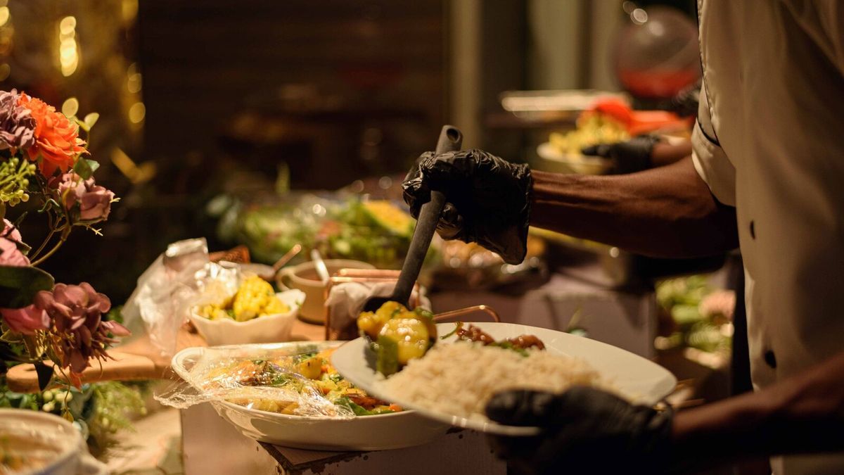 Chef serving guests from a varied event buffet